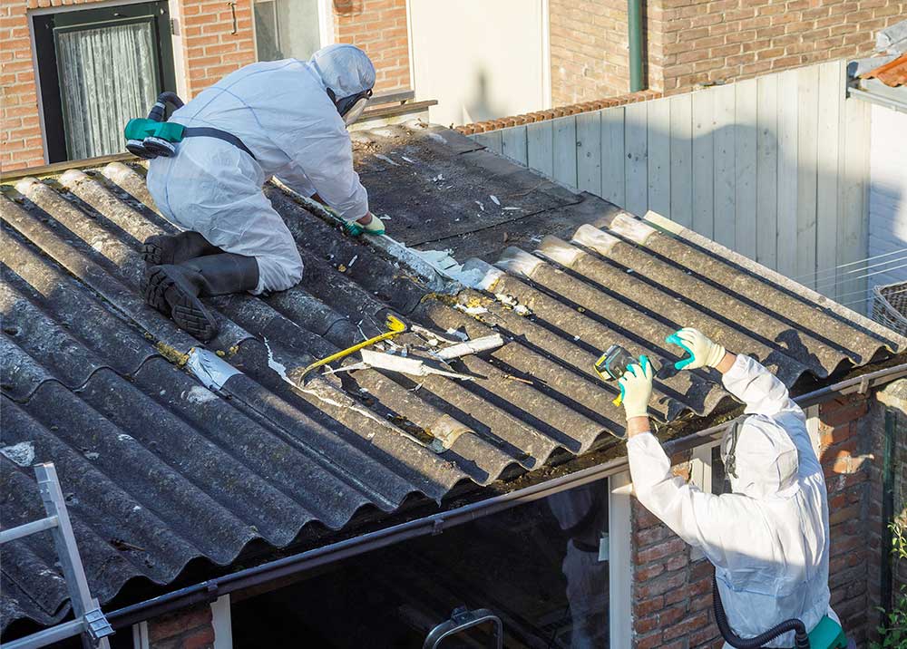 Asbestos abatement professionals remove asbestos roofing