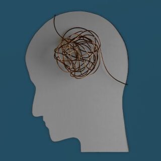 This image depicts a light gray silhouette of a person's head and neck set against a dark gray background. A ball of tangled yarn sits atop the silhouette where the brain would be, metaphorically depicting the mental challenges of chemo brain.