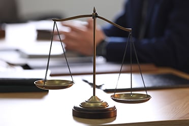 Image of scales of justice in a lawyer's office