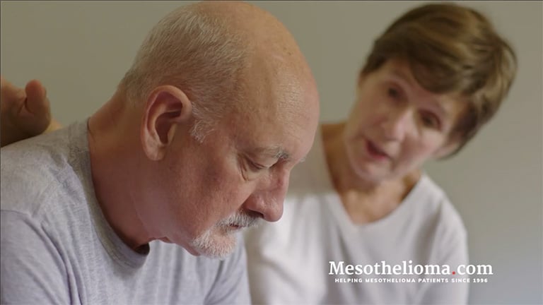 Still frame of a wife comforting her husband after a mesothelioma diagnosis from a video about Mesothelioma.com's free mesothelioma guide